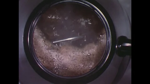 1960s: Down shot of coffee in percolator / Coffee poured from percolator into Stock Footage