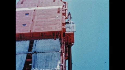 1960s: Elevator reaches top of rocket launch pad with astronauts inside. 動画素材 101665311
