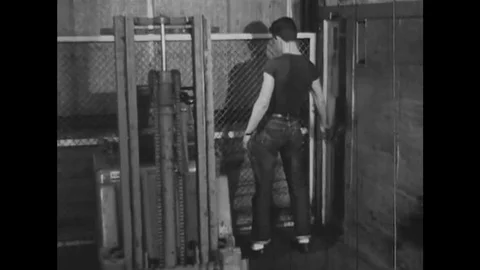 1960s - An employee operates an elevator and tries to operate a forklift, and 動画素材 132203310