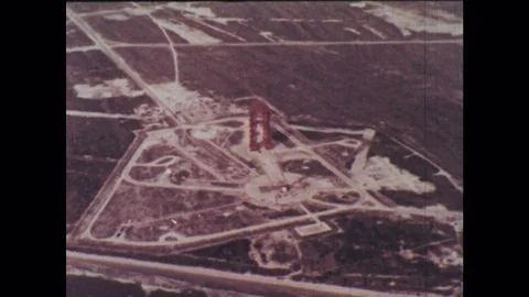 1960s: Empty landscape with paths. Rocket  in stationary, upright position Stock Footage 77448930