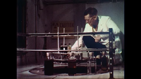 1960s : Engineer Tests Lubrication Oils Inside Radiation Room Stock Footage 74674522
