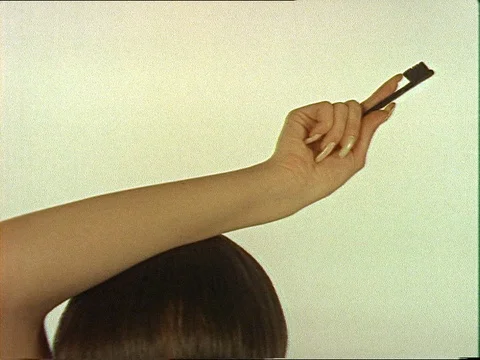 1960s: ENGLAND TEEN FEMALE FASHION: model dances & chances clothes (no rights to Stock Footage