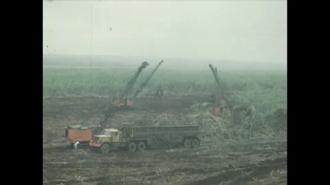 1960s: An excavator operating in a coal mine, scooping up coal from a pile and Stock Footage 280145872