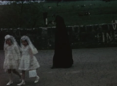 1960s First Holy Communion Procession with Nuns and Priest – Vintage 8mm Film Stock Footage 329075394