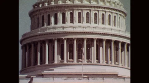 1960s: Flag flies on pole outside capitol building. Dome of capitol building. Stock Footage 122015542