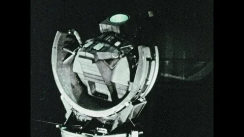 1960s: Flight simulator. Man looks out window of simulator at command module. 库存影片 100302723