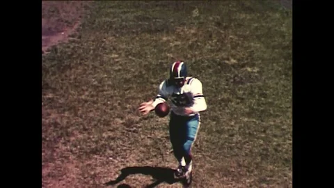 1960s: Football player kicks ball, words 'Hi-Velocity' fly towards camera / Stock Footage