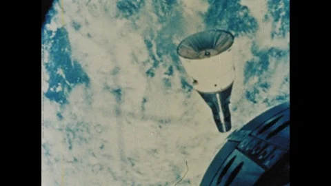 1960s: Gemini command module floats in Earth's orbit. Video stock 101665501