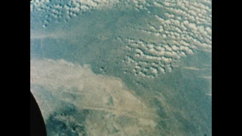 1960s: Gemini space craft floats above clouds and terrain in Earth's orbit. Stock Footage 101665461