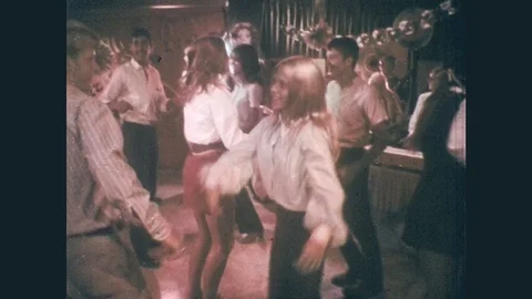 1960s: Girl smiles, young people do groovy dance at party, rock band plays. Stock Footage