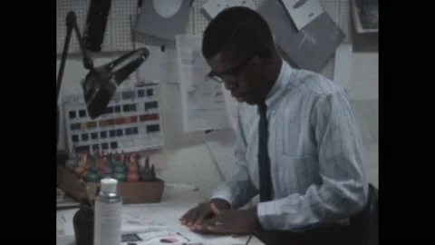 1960s: hand claps loader board in front of actor. Man works at desk.  Man sprays Stock Footage 192253484