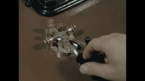1960s: Hand tapping out morse code on the telegraph key. Stock Footage 295082329