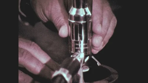 1960s: Hands adjust Bunsen burner. Boy browses shelf of chemicals. Chemical Stock Footage
