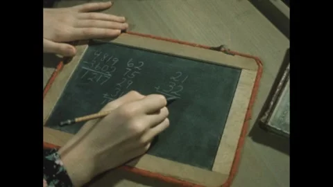 1960s: Hands doing math problem on chalkboard. Stock Footage 246751582