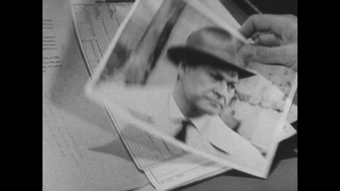 1960s: hands open folder, photo of man in hat, boats on river, trucks on busy Stock Footage 125953014