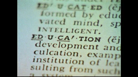1960s: Hands turn pages of book / Close up views of dictionary entry. Stock Footage 74665699