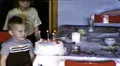 1960s Happy Little Boy Blows out Birthday Cake Candles Vintage Film Home Movie HD Footage