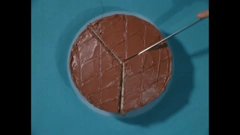 1960s: High angle view of cake, hand slicing cake with knife. Stock Footage 271091547
