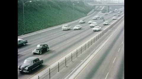 1960s: High angle views of traffic on highway, motorcycles driving on highway. Stock Footage