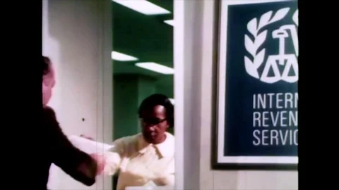 1960s - The IRS' process of calculating a man's tax return is depicted. Video stock 124085323