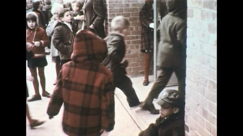 1960s: Kids walk into school / Teacher with kids in classroom / Older students Stock Footage