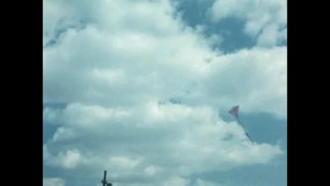 1960s: Kite sways back and forth in blue sky. Stock Footage 244482663