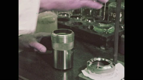 1960s: Lab.  Scientist puts piece of cake into machine.  Man turns knob on 動画素材 149641762