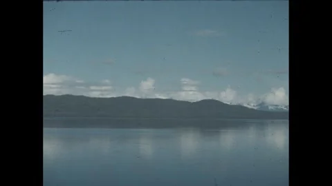 1960s: Large mining trucks transport coal in a massive open pit coal mine. The Stock Footage 280145882