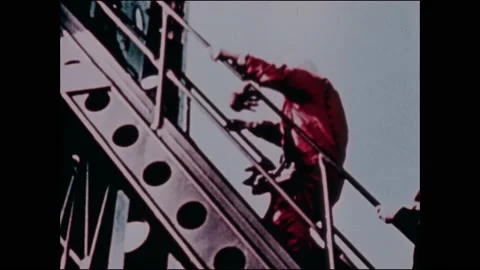 1960s: Launch pad.  Man climbs steps to get into rocket.  Man waves.  Elevator 動画素材 159490226