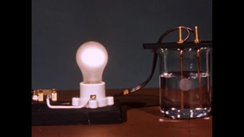1960s: Lightbulb is lit while wires goin... | Stock Video | Pond5