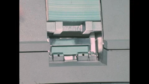 1960s: Lights on server machine. Man sits at keyboard printer in server room. Stock Footage 276504396