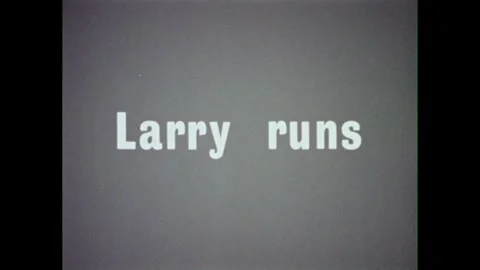 1960s: List of words is categorized as "DOING WORDS."  Little boy runs.  Text Stock Footage 311772485