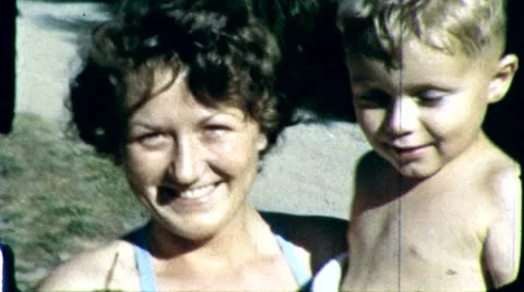 1960s Loving Happy Pretty MOTHER HOLDING SON Toddler Boy Vintage Film Home Movie Stock Footage