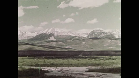1960s: Low angle, men ride past on horseback. View of mountains. Map of western Stock Footage 146797883