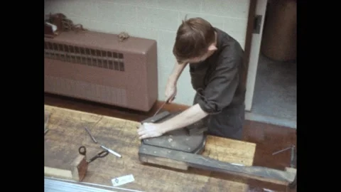 1960s: Man forming wire into ring. Net being put onto ring. Teacher sitting with Video stock 167959954