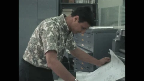 1960s: Man leans over table, looks at paper. Man shakes another person's hand, Stock Footage 194489769