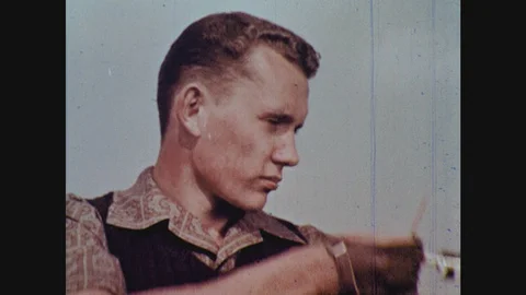 1960s: man pulling back bowstring and preparing to shoot an arrow Stock Footage 124818045
