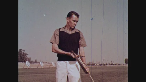 1960s: man pulling back bowstring and preparing to shoot an arrow Stock Footage 124818051