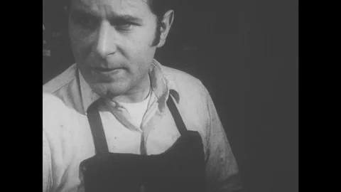 1960s: Man repairs shoe Stock Footage