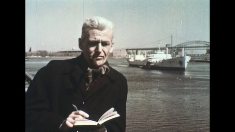 1960s: Man takes notes next to harbor. Stock Footage 74779091