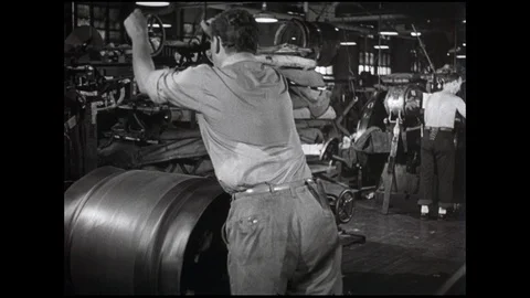 1960s: Man turns knobs and watches tire and rubber spin on building machine in 스톡 동영상 109382345