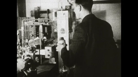 1960s: Man working in lab. Man adjusting controls. Close up of gauge moving. Stock Footage 129972056