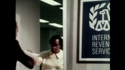 1960s - A man's 1040 form is processed by the IRS and he receives a refund Video stock 118442507