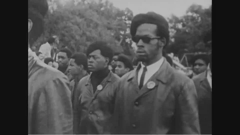 1960s - Members of the Black Panther Party march to a band. Stock Footage