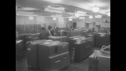 1960s: Men in room with computers. Men operating computers. People typing punch Stock Footage 94465559