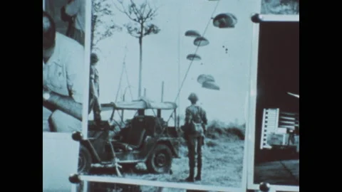 1960s: Men shaking hands. Man watches parachutes landing. Plume of smoke. Hand Stock Footage 143365091