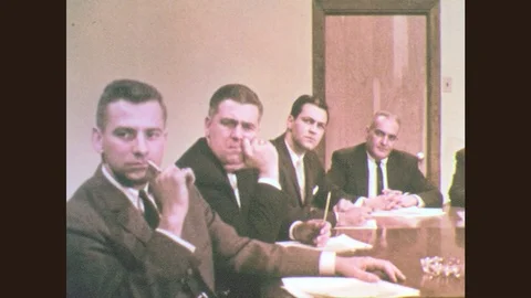 1960s: Men sit at table.  Men listen.  Men fidget. Stock Footage 77981544