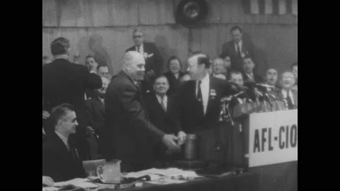 1960s: men on stage with AFL-CIO sign at podium, audience stands, applauds, Stock Footage 133944978