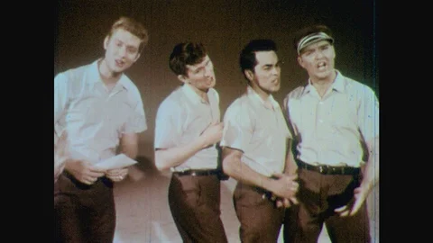 1960s: Men stand in line.  Men and women sing.  Nurses dance. Stock Footage 123864154
