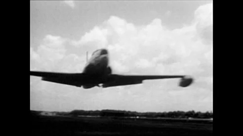 1960s: Men watch airplanes take off.  Soldiers get onto airplane. Stock Footage 128192377